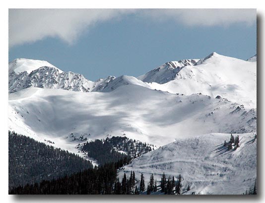 Telephoto view of the back side of  A Basin ski resort.  Just to the right of  center is a dip which is the top edge of the lift area.  Nikon CP 5700 max zoom plus teleconverter.